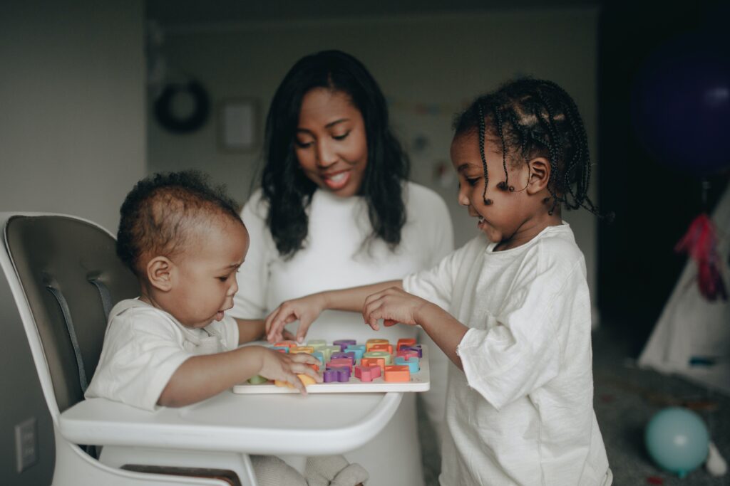 Woman and two children playing game